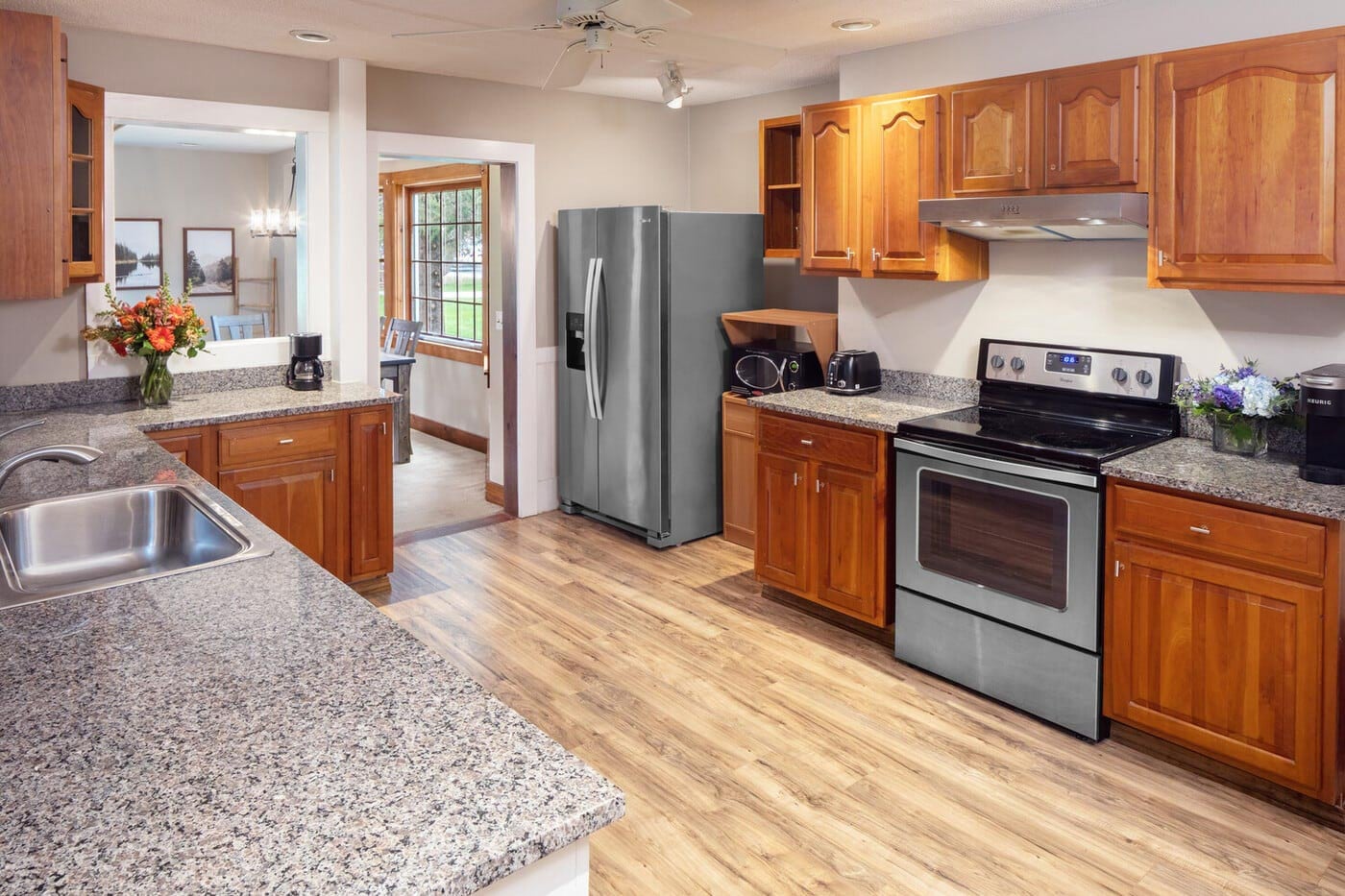 A kitchen with granite counter tops and stainless steel appliances.